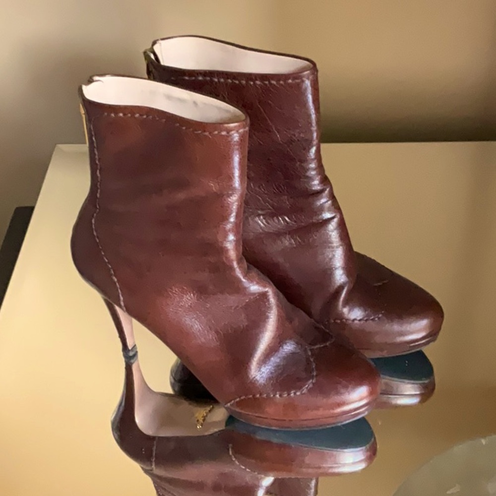 Brown Prada boots with slight elevation.